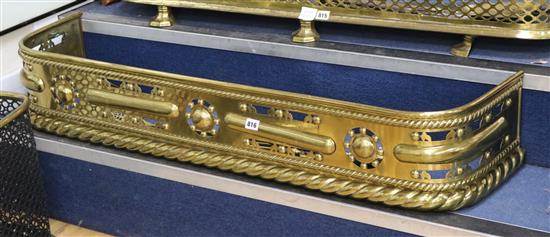 A Victorian brass D-shaped fender, with rope borders and pierced frieze, together with three Victorian fire irons W.4ft